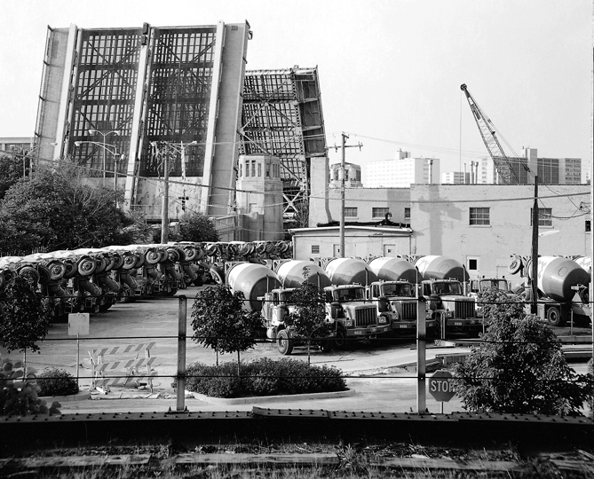 no longer standing,
		this bridge once carried Ogden Avenue traffic over the Chicago River's 
		North Fork. In the right side background are some of the high rise housing 
		project buildings known as Cabrini Green